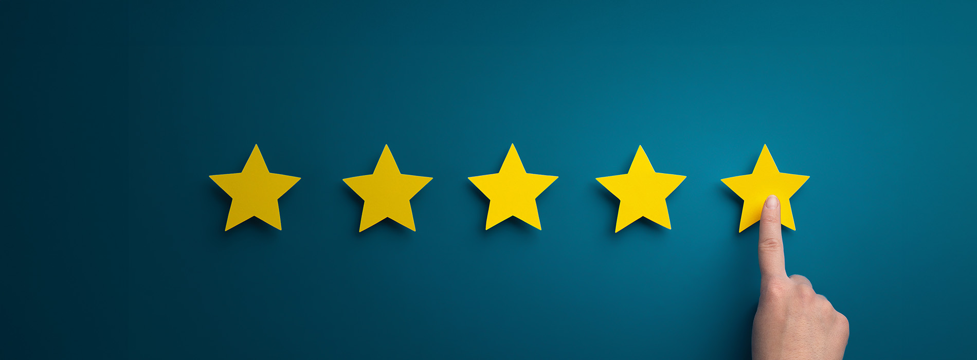 The image shows a graphic banner with a blue background at the top and a dark blue border on either side, featuring a row of five yellow stars aligned horizontally, followed by a single yellow star pointing upwards with a hand pointing towards it from the bottom right corner.