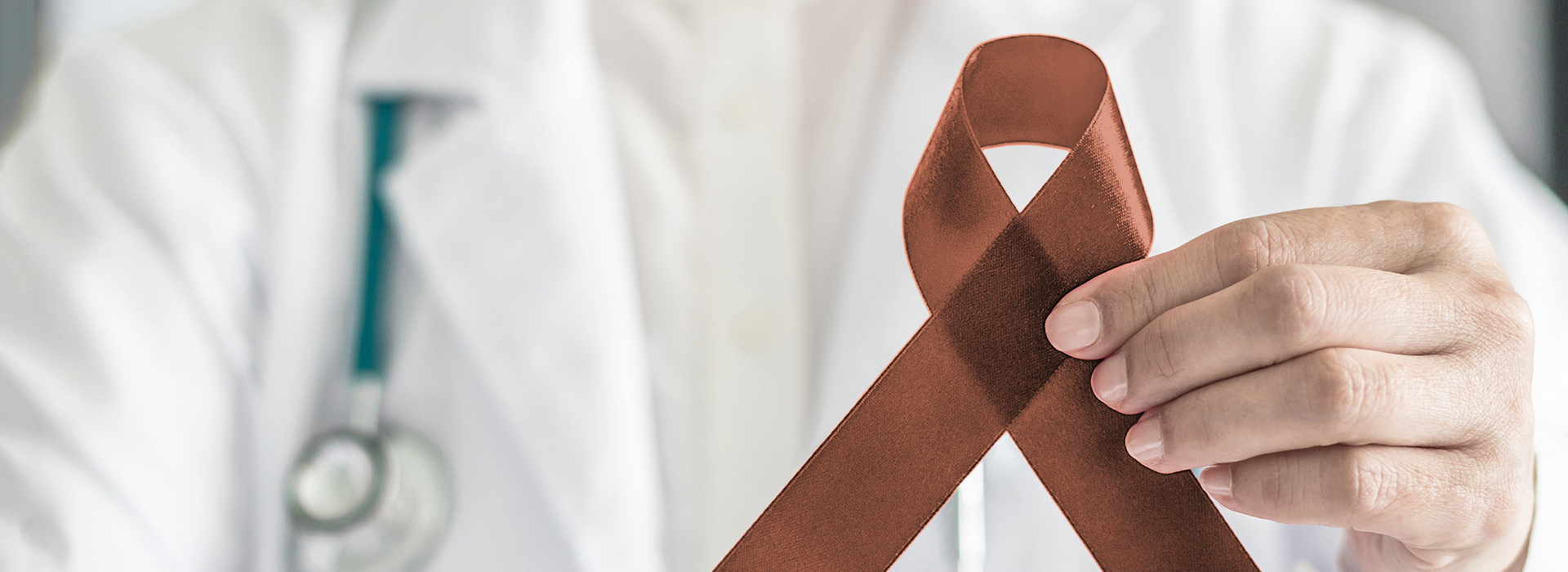 The image features a medical professional holding a red ribbon symbolizing awareness for a specific health issue, with the text  AIDS  prominently displayed on the ribbon.