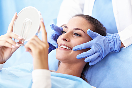 This is a digital composite image showing two different scenes of medical care  on the left, a woman with blue eyes is holding up a magnifying glass over her face while smiling at the camera  on the right, a person s head is being examined by a healthcare professional wearing gloves and a surgical mask.