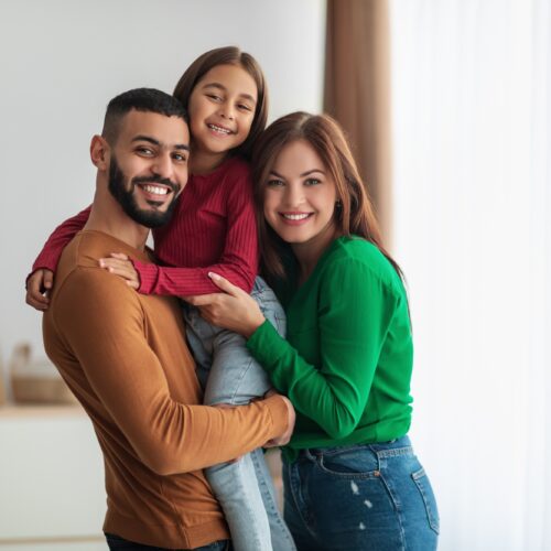 Happy family smiling after restorative dental care at Plaza Dental Parker in Parker, CO