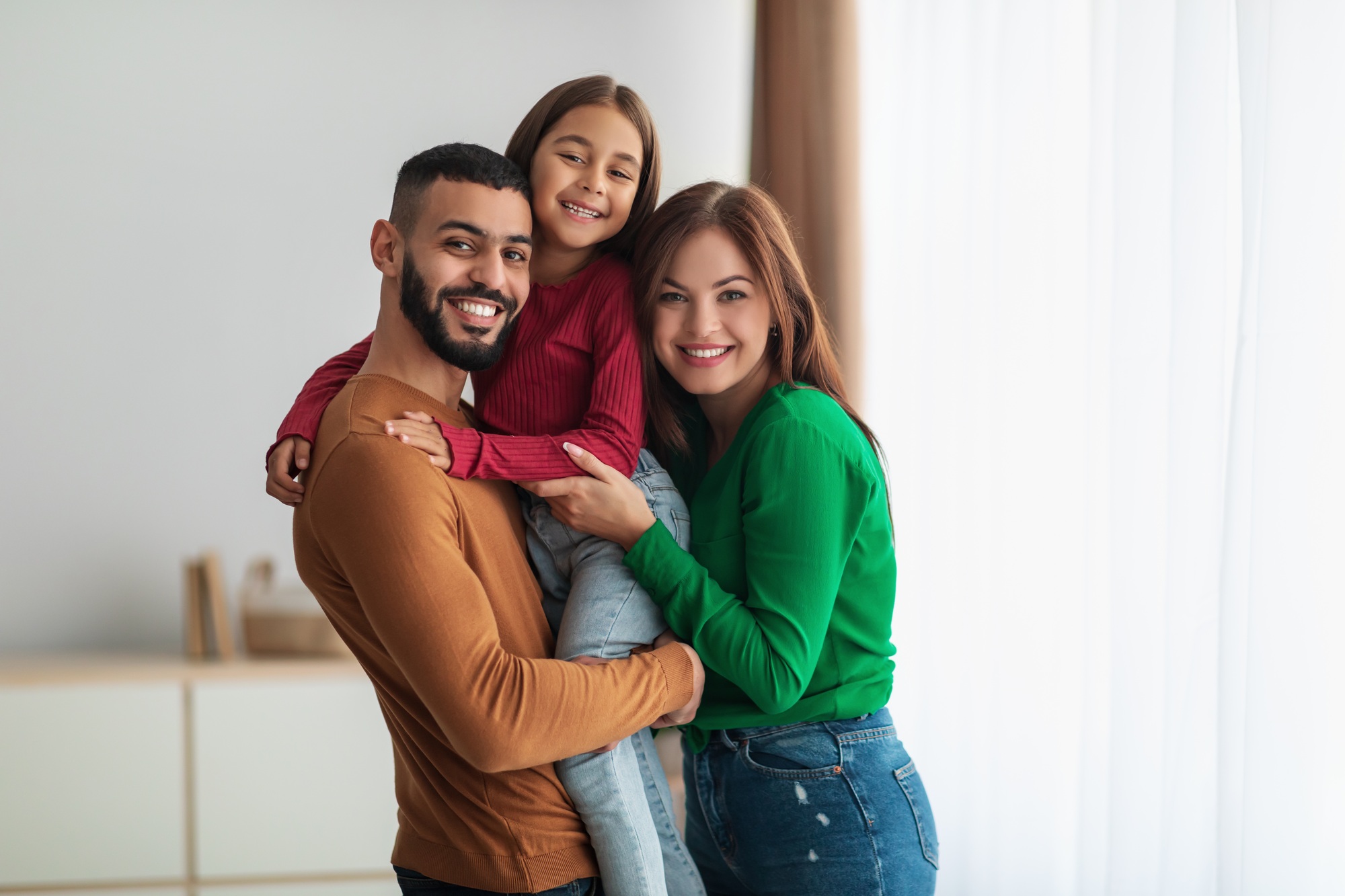 Happy family smiling after restorative dental care at Plaza Dental Parker in Parker, CO